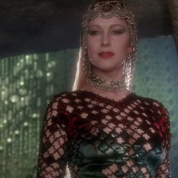 Helen Mirren as Morgana in John Boorman's "Excalibur" embodies the seductive and dangerous sorceress of Arthurian legend. Woman in elaborate scaled armor with ornate golden headpiece in mystical cave setting from 1981 Excalibur film.